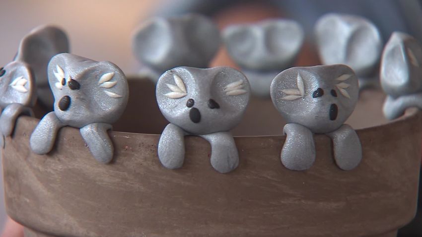 Boy makes clay koalas