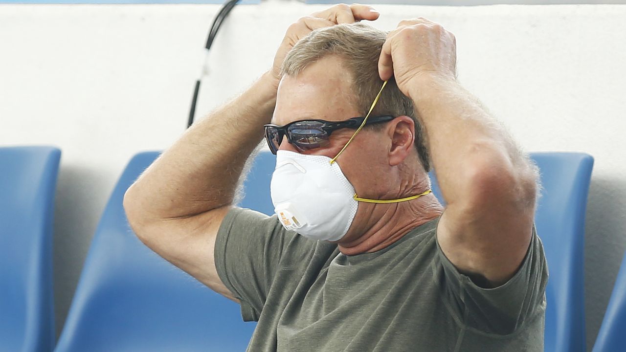 A fan wears a respiratory mask during Australian Open qualifying matches.