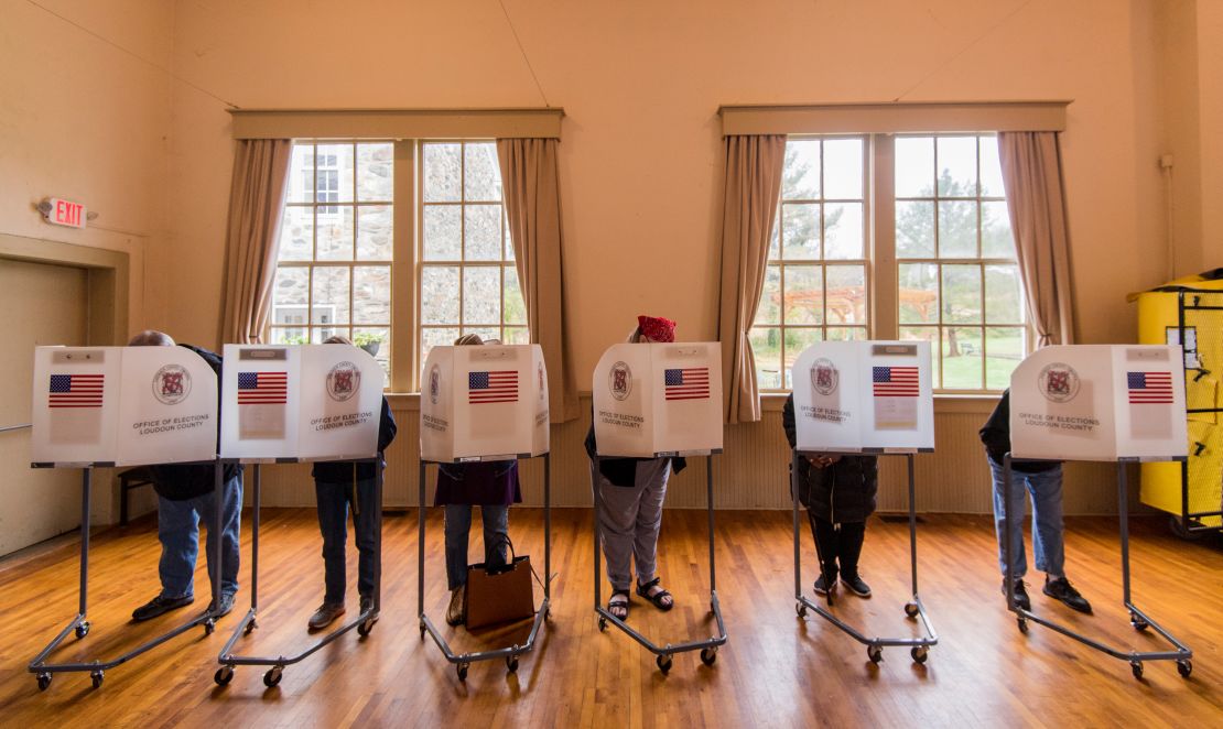 Voters fill out their ballots at a polling station in Virginia in 2018. 