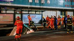 Chinese rescuers preparing to lift a bus after a road collapse in Xining in China's northwestern Qinghai province. 