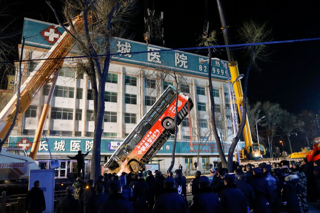 A bus swallowed by a huge sinkhole is lifted out after a road collapsed in Xining in China's northwestern Qinghai province.