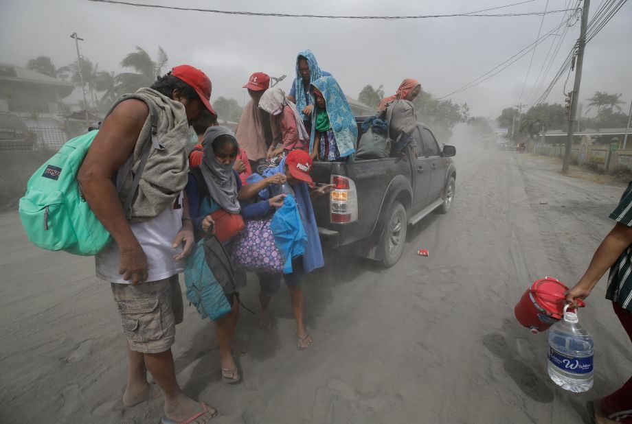 A family flees to safer ground as the volcano produces ash in Tagaytay on Monday, January 13.