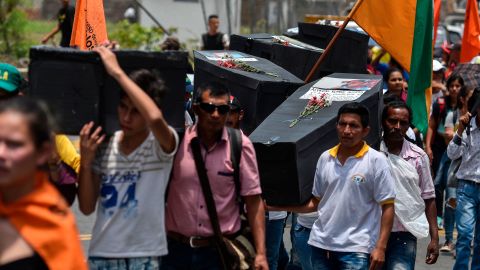 Residents carry makeshift coffins in solidarity with victims of violence in Cali, Colombia, in April 2018.