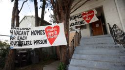 Signs are posted outside of a house that was occupied by homeless women in Oakland, Calif., Tuesday, Jan. 14, 2020. Homeless women ordered by a judge last week to leave a vacant house they occupied illegally in Oakland for two months have been evicted by sheriff's deputies. They removed two women and a male supporter Tuesday from the home before dawn in a case highlighting California's severe housing shortage and growing homeless population.