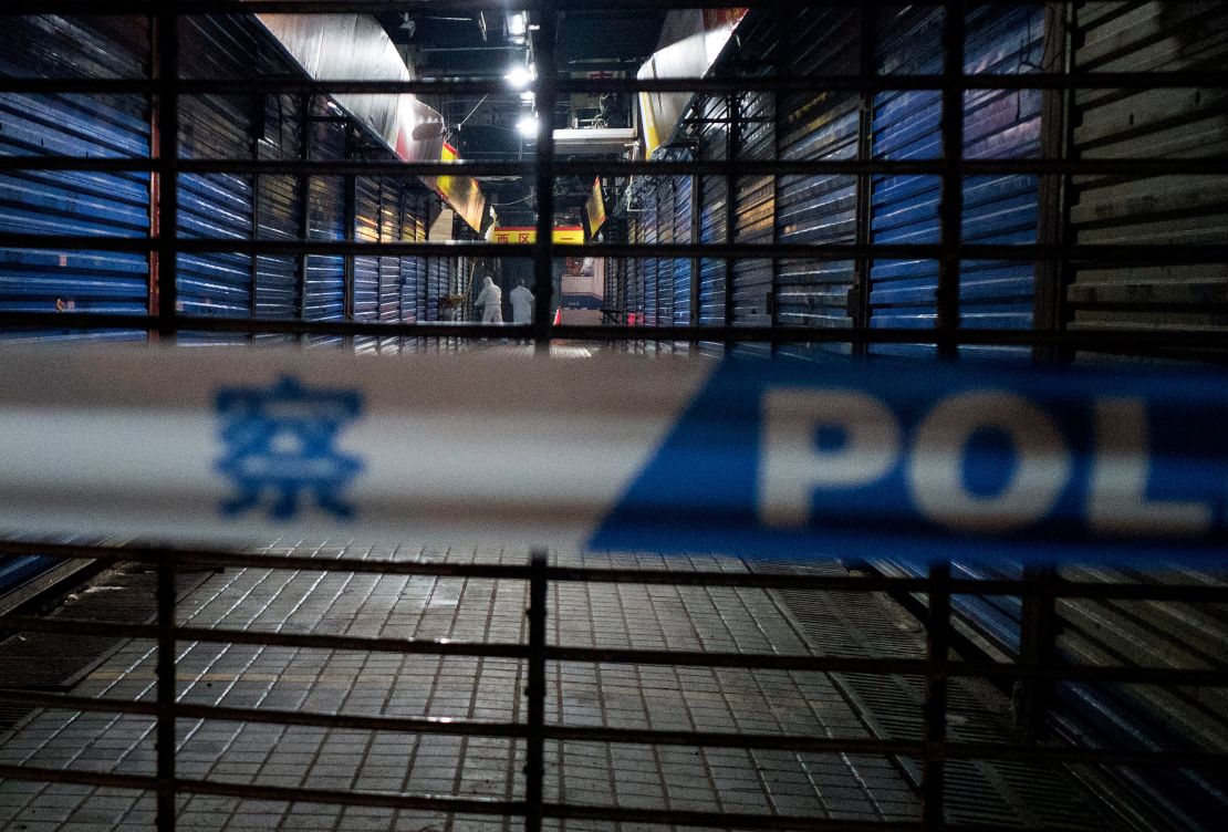 Members of staff of the Wuhan Hygiene Emergency Response Team conduct searches on the closed Huanan Seafood Wholesale Market in Wuhan.
