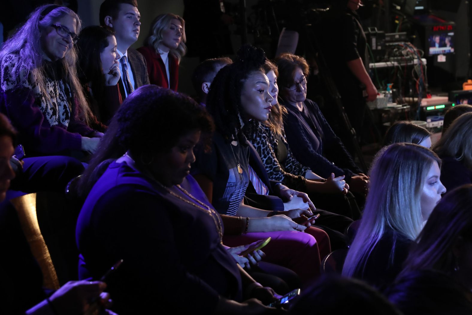 Audience members look on prior to the debate.