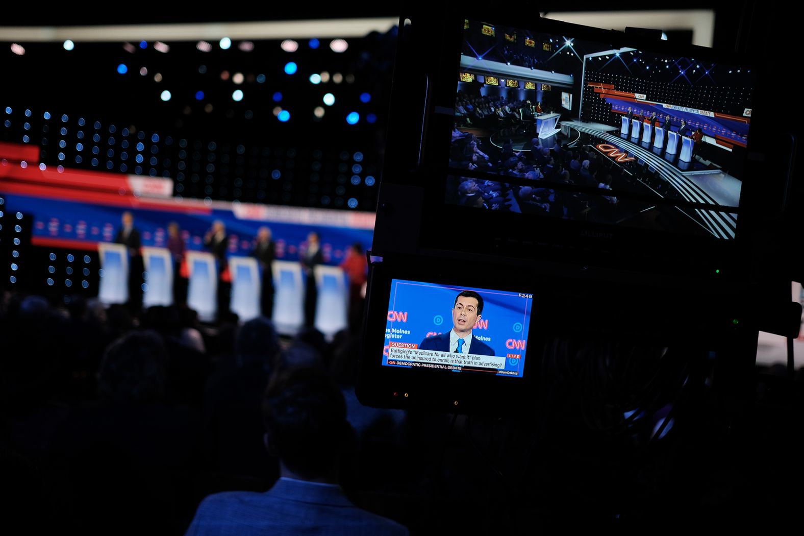 Buttigieg is seen on a screen at the debate venue. "If you're used to voting for the other party but right now cannot look your kids in the eye and explain this President to them, join me," he said in his closing statement.