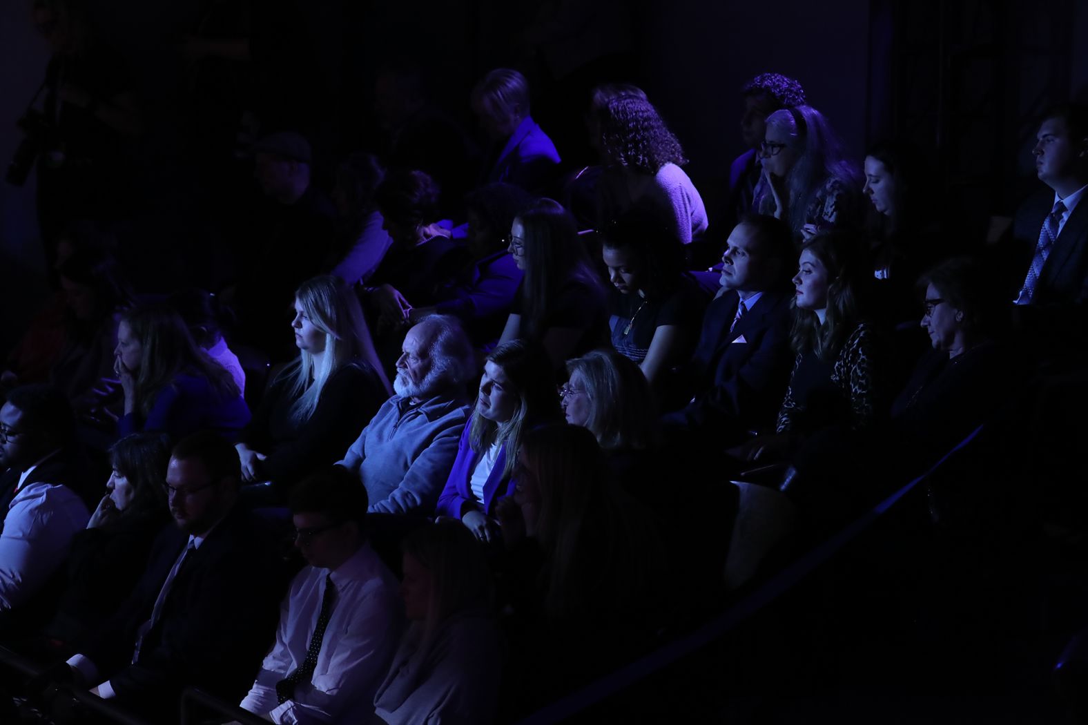 Audience members watch the debate.