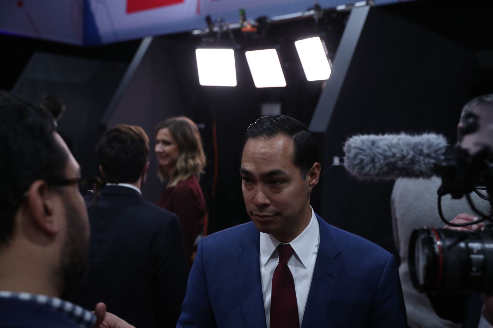 Former presidential candidate Julian Castro speaks to media members in the spin room.