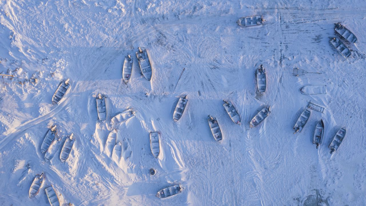 Boats dot the frozen landscape of Toksook Bay in December. In warmer months, boats are used for transportation and fishing.