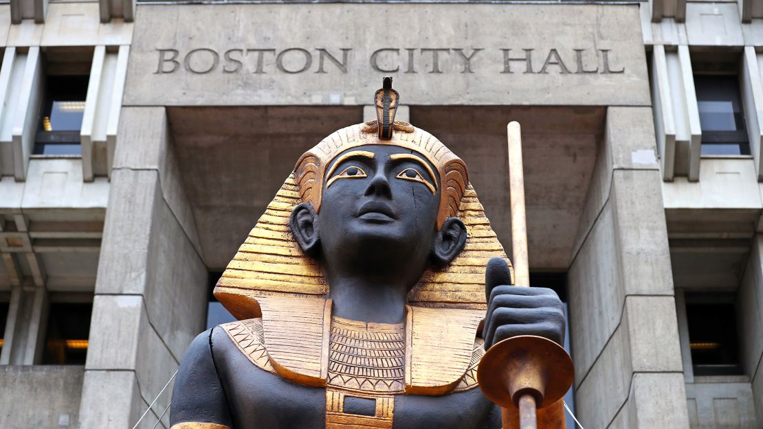 A giant gold and black statue of an Egyptian tomb guardian is placed in Boston's City Hall Plaza to promote an immersive exhibit coming to Boston this June.