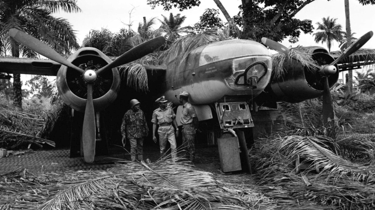 Soldiers posing in front of a captured plane, during the Nigerian conflict with Biafran forces, Nigeria, 1968. 