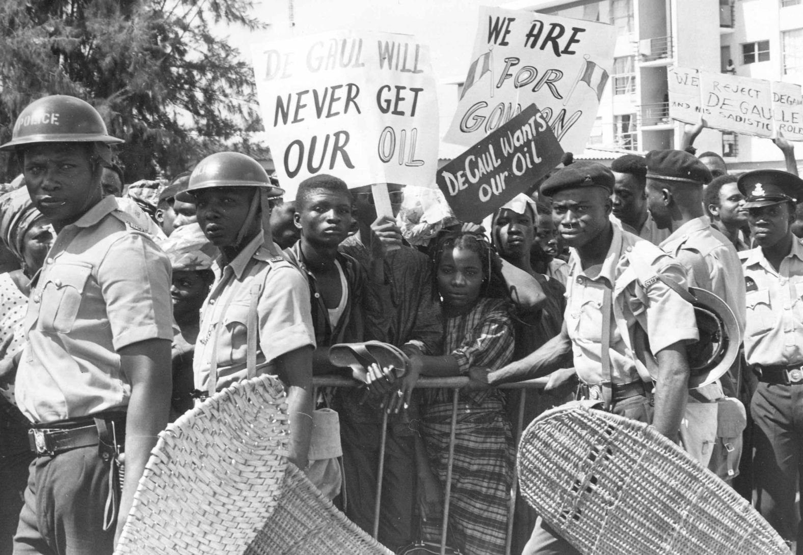 Nigerian police push back crowds of demonstrators outside the French Embassy in Lagos on September 16, 1968. An estimated 2,000 demonstrators presented the French ambassador with a letter protesting French assistance to Biafra. France provided weapons and mercenary fighters to Biafra and promoted their cause internationally, describing the situation as a genocide. <br />