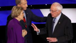 Presidential candidates Elizabeth Warren and Bernie Sanders speak following the Democratic debate in Des Moines, Iowa, on January 14.