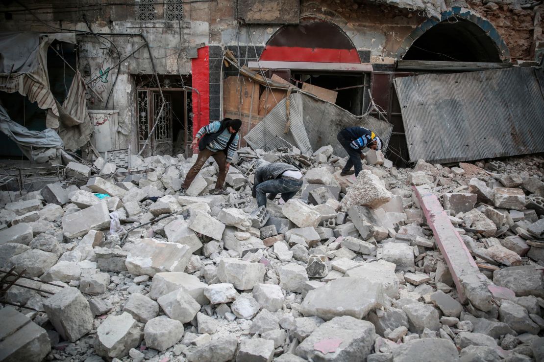 People search for victims or survivors under the rubble at the popular market in the city of Ariha on Jan. 15, airstrikes on the rebel-held Idlib province.