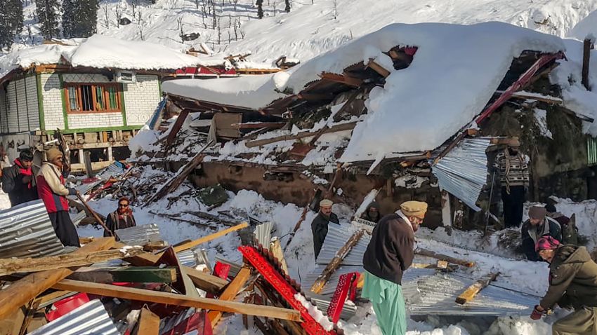 Local residents remove debris of a collapsed house following heavy snowfall that triggered an avalanche in Neelum Valley, in Pakistan-administered Kashmir on January 14, 2020. - At least 42 people were killed and 21 wounded after heavy snowfall and rain hit Pakistan-administered Kashmir and the country's southwest, officials said. (Photo by STR / AFP) (Photo by STR/AFP via Getty Images)