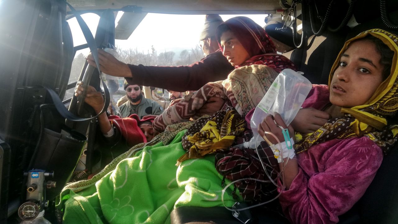 Injured avalanche victims arrive in in Muzaffarabad in an army helicopter following heavy snowfall in the Neelum Valley, in Pakistan-administered Kashmir on January 14, 2020.
