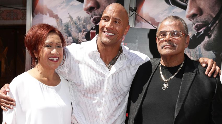 Ata Johnson, Dwayne Johnson and Rocky Johnson seen at Dwayne Johnson's Hands and Footprints Ceremony held at TCL Chinese Theatre on Tuesday, May 19, 2015, in Hollywood. (Photo by Eric Charbonneau/Invision for Warner Bros./AP Images)