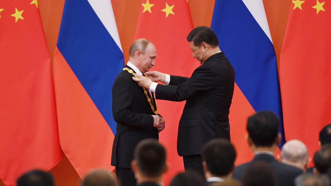 Chinese President Xi Jinping congratulates Russian President Vladimir Putin after presenting him with the Friendship Medal in the Great Hall of the People on June 8, 2018 in Beijing, China.