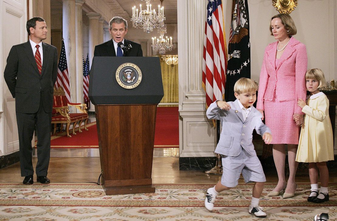 Federal appeals court judge John G. Roberts Jr.'s (L) son John (3rd R) dances as US President George W. Bush (C) announces Roberts as his first Supreme Court nominee during a prime-time speech 18 July 2005 from the White House in Washington as Roberts wife Jane (2nd R), duaghter Josephine (R) look on.   