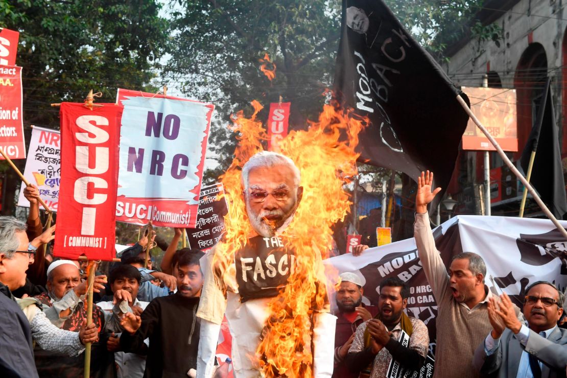 Activists of the Social Unity Center of India (SUCI) burn an effigy of India's Prime Minister Narendra Modi as they participate in a protest against India's new citizenship law, in Kolkata on January 11, 2020. 