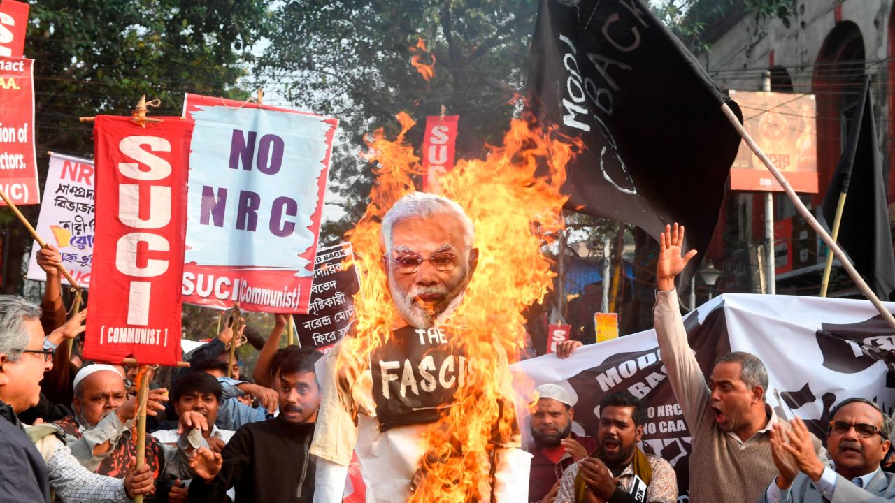 Activists of the Social Unity Center of India (SUCI) burn an effigy of India's Prime Minister Narendra Modi as they participate in a protest against India's new citizenship law, in Kolkata on January 11, 2020. 