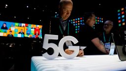 People loook at 5G phones at the Samsung booth during the CES tech show, Tuesday, Jan. 7, 2020, in Las Vegas. (AP Photo/John Locher)