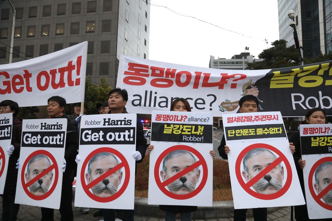 Members of Seoul Jinbo, a civic group of progressive activists, hold a rally near the residence of US Ambassador to South Korea Harry Harris in Seoul on November 11, 2019. His face is superimposed with a cat because he joked on Twitter that his cats were OK after a group of students broke into his house.