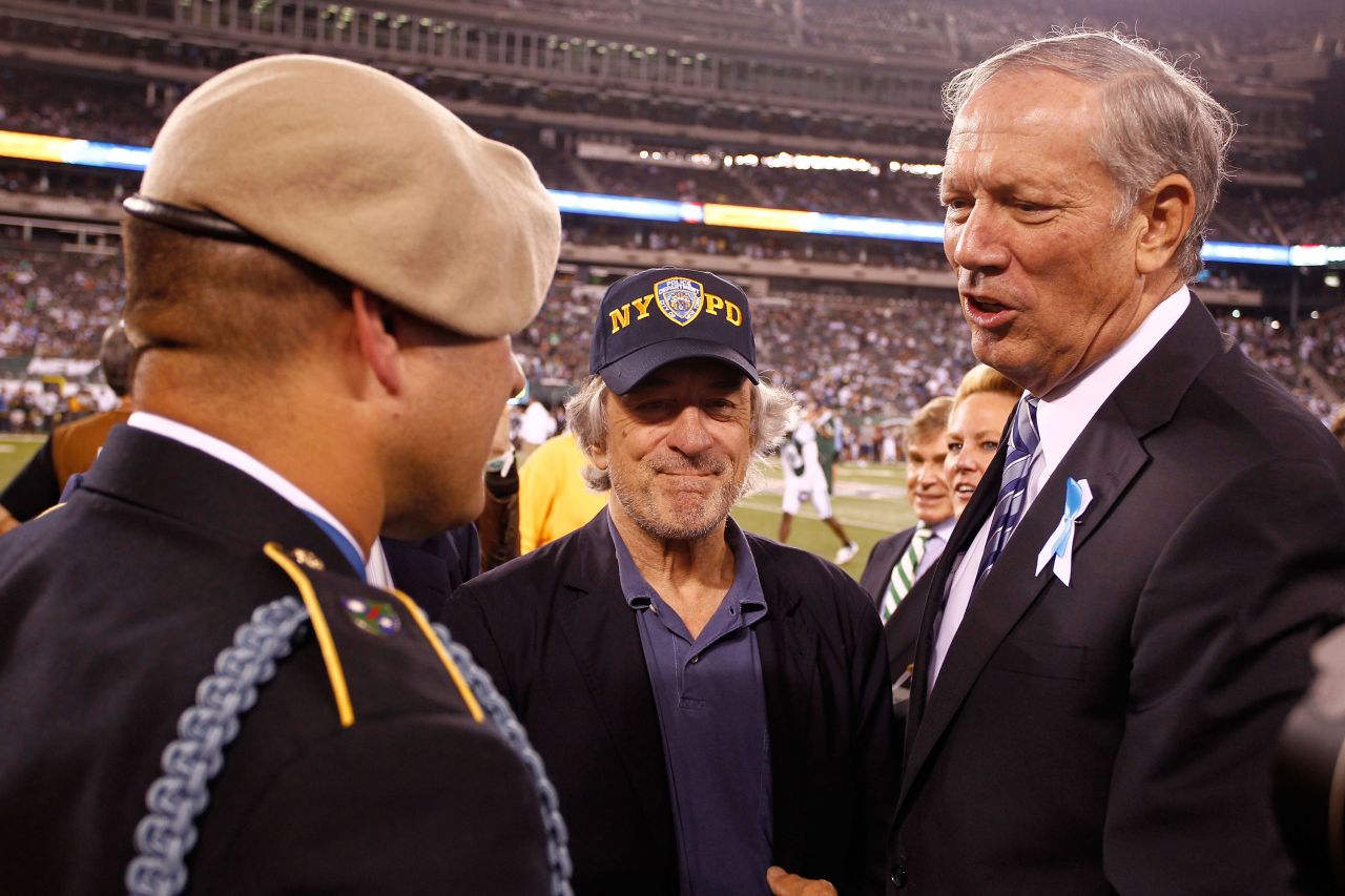 US Army Sgt. 1st Class Leroy Petry, a Medal of Honor winner, talks with De Niro and former New York Gov. George Pataki before an NFL football game in 2011.