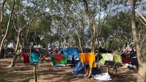 Migrants wait at a makeshift camp in Matamoros, Mexico to claim asylum in the US. The camp sits just feet from a port of entry into the United States.