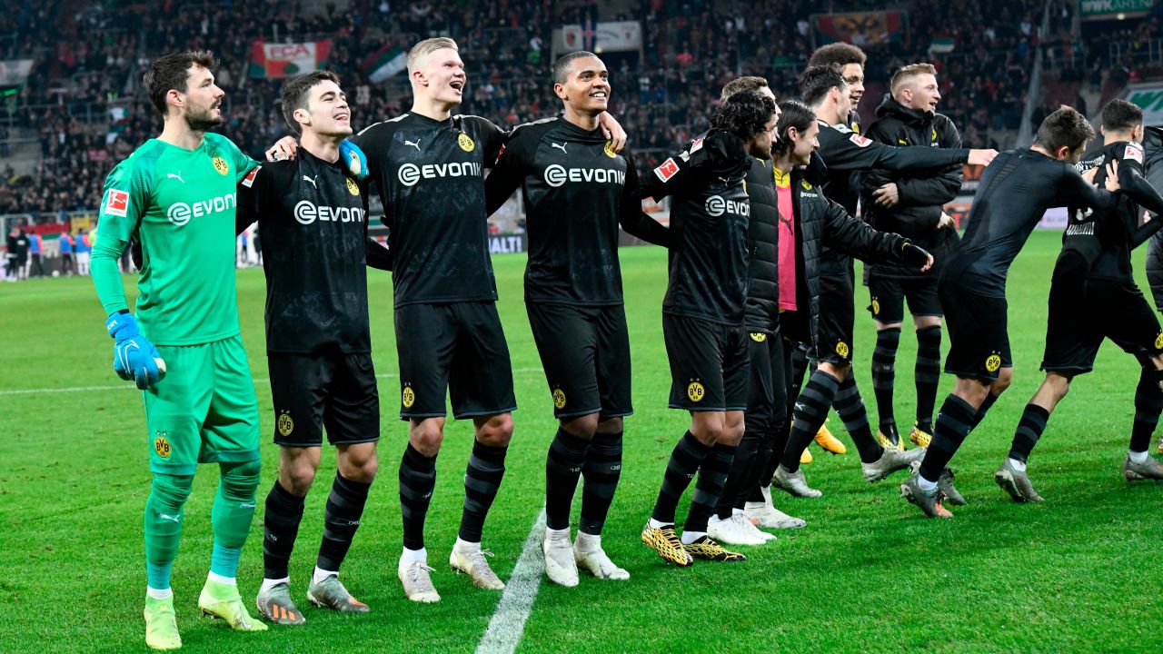 Dortmund's players celebrate after defeating Augsburg.