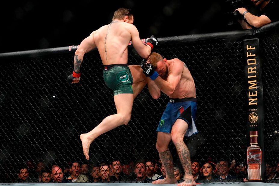 McGregor lands a knee to the face of Cerrone. McGregor blitzed Cerrone from the opening bell and won the fight less than a minute into the first round.