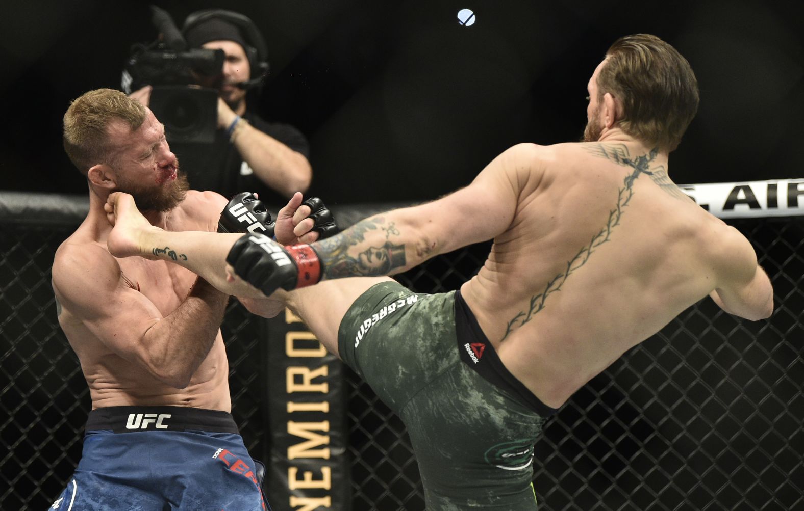 McGregor kicks Cerrone in the face.