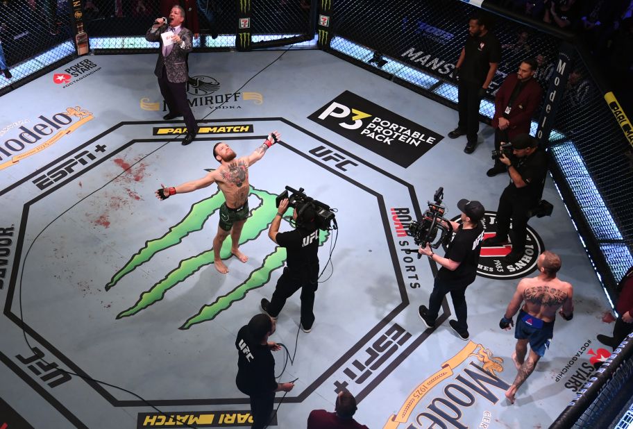 McGregor celebrates after defeating Cerrone. McGregor improves his career professional record to 22-4 with 19 knockouts.