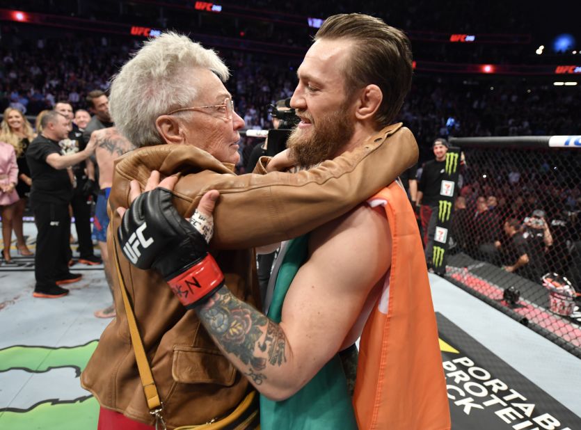 Conor McGregor is hugged by Jerry Cerrone, the grandmother of Donald Cerrone, after the bout.