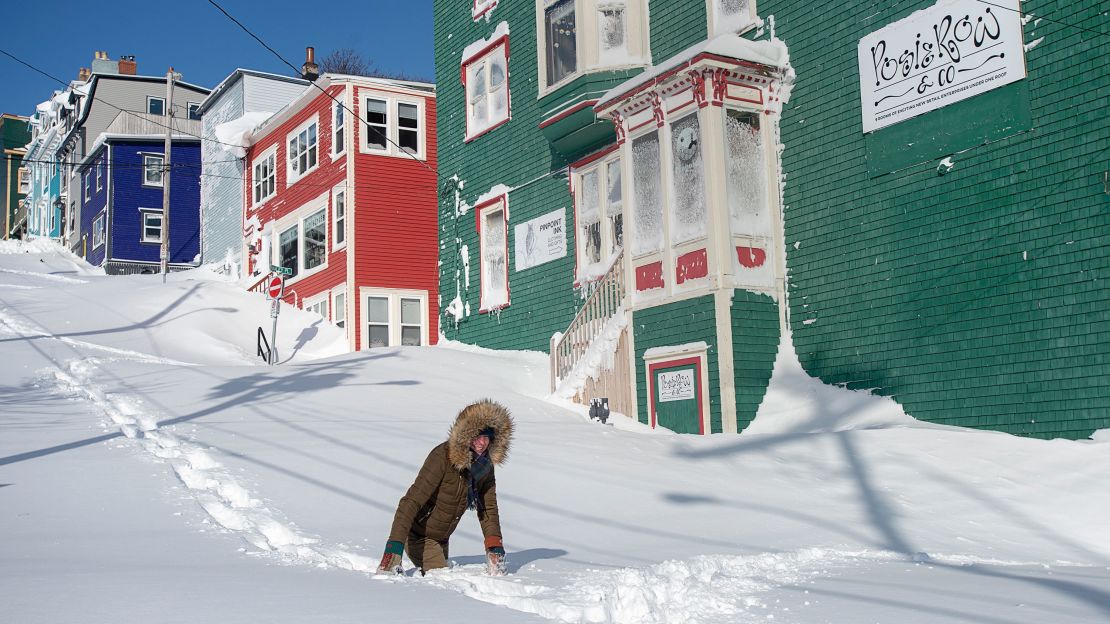 A resident trudges through heavy snow in St. John's, Newfoundland, on Saturday.