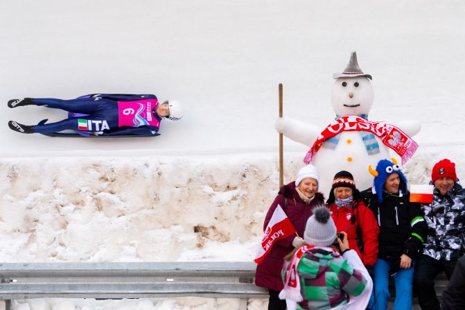 People pose for a photograph as Italy's Katharina Putzer competes in the luge during the Lausanne 2020 Winter Youth Olympics on Friday, January 17, in St. Moritz, Switzerland.