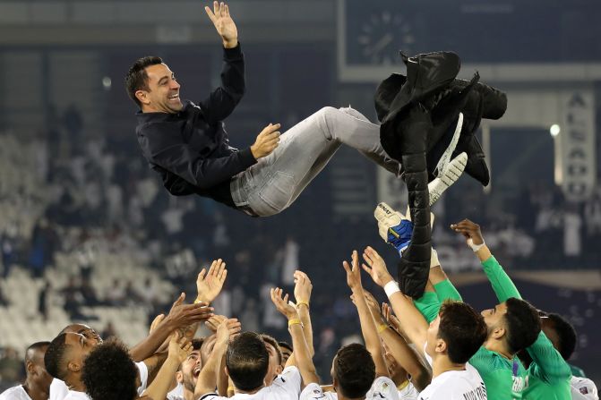 Al-Sadd throws its coach Xavi Hernandez into the air after winning the final match of the Qatar Cup against Al-Duhail on Friday, January 17. Al-Sadd won the match 4-0.