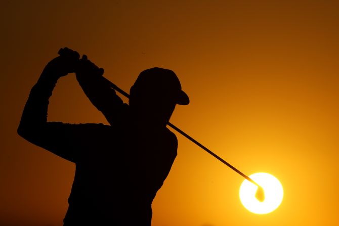 Louis Oosthuizen of South Africa practices as the sun rises on day one of the Abu Dhabi HSBC Championship on Thursday, January 16, in the United Arab Emirates. <a  target="_blank">See 28 more amazing sports photos</a>