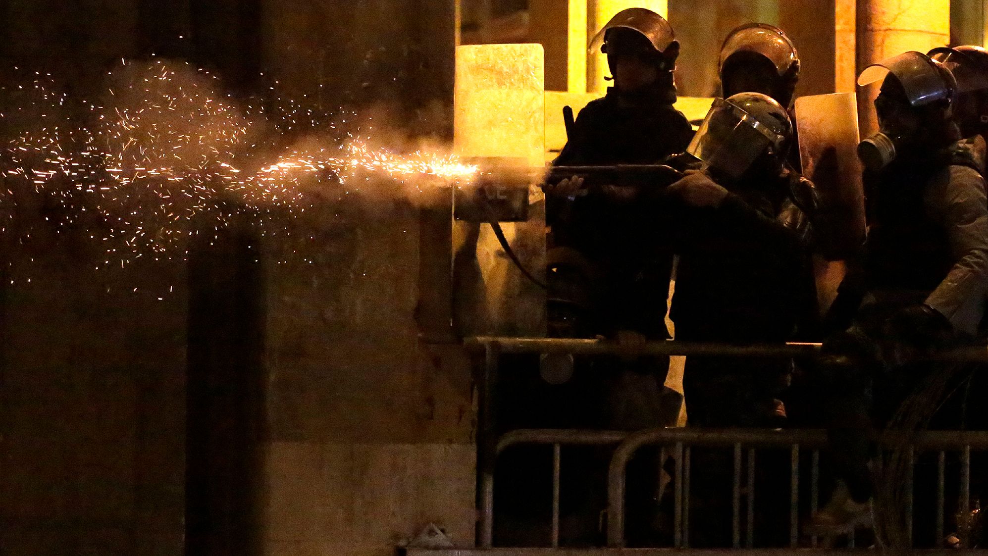 Riot police fire rubber bullets against the anti-government protesters Sunday.