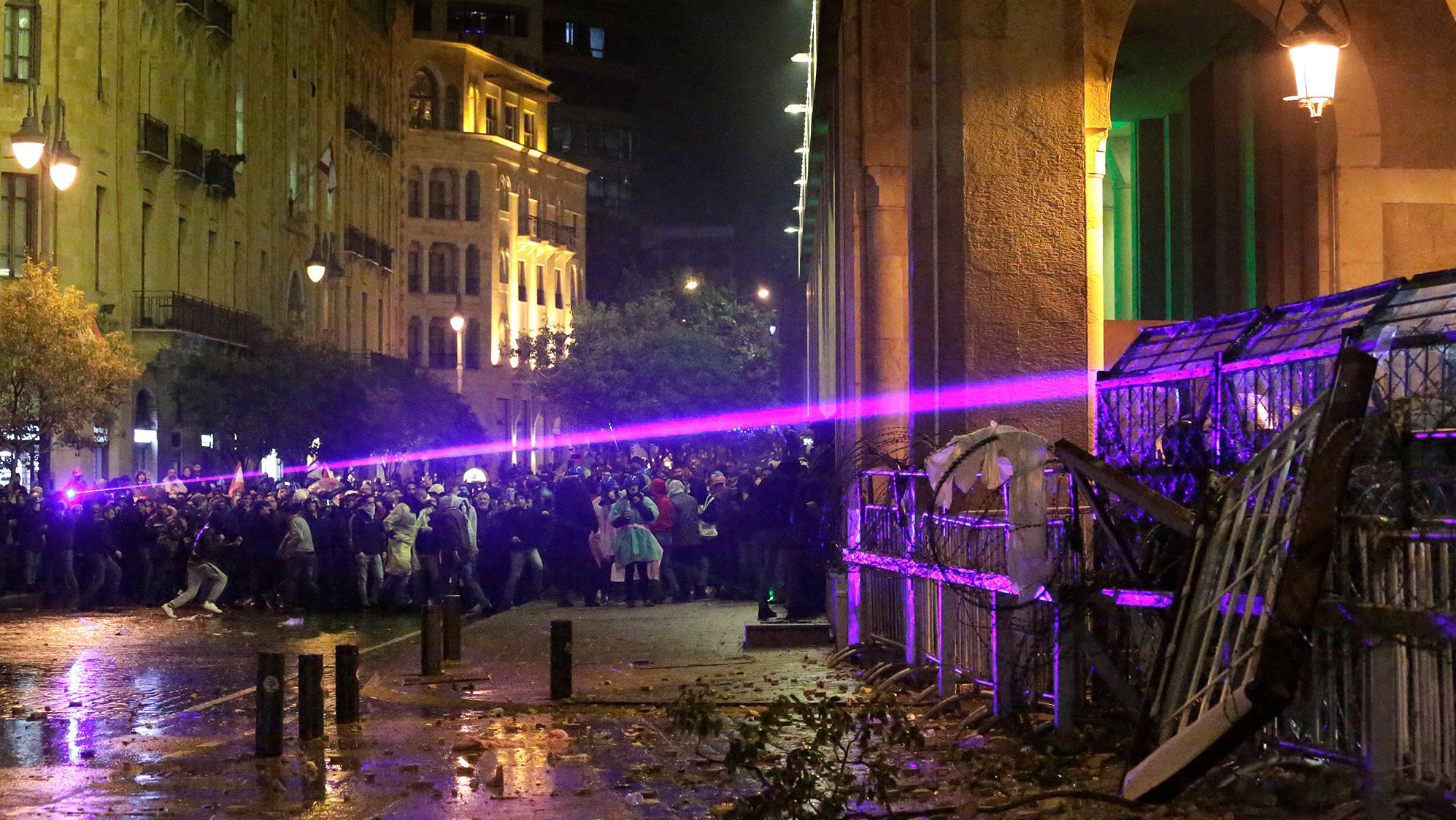 Anti-government protesters use lasers as they clash with the riot police.