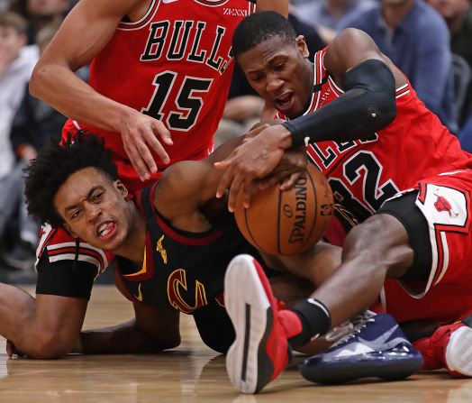 Kris Dunn of the Chicago Bulls forces a jump ball with Collin Sexton of the Cleveland Cavaliers on Saturday, January 18, in Chicago, Illinois. The Bulls defeated the Cavaliers 118-116.