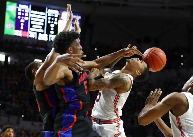 Omar Payne of the Florida Gators blocks a shot by J'Von McCormick of the Auburn Tigers during the second half in Gainesville, Florida, on Saturday, January 18. Florida won 69-47.