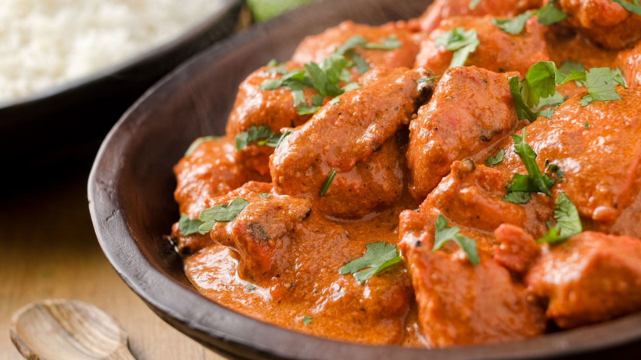Butter chicken curry with basmati rice and limes. 