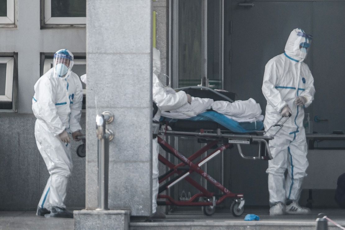 Medical staff members carry a patient into Wuhan's Jinyintan hospital, where patients infected by the Wuhan coronavirus are being treated, on January 18, 2020.