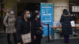 People walk next to signage detailing hygenic practices to prevent the spread of a SARS-like coronavirus at the Huashan Hospital in Shanghai on January 21, 2020. - China has confirmed human-to-human transmission in the outbreak of a new SARS-like virus as the number of cases soared and the World Health Organization said it would consider declaring an international public health emergency. (Photo by HECTOR RETAMAL / AFP) (Photo by HECTOR RETAMAL/AFP via Getty Images)