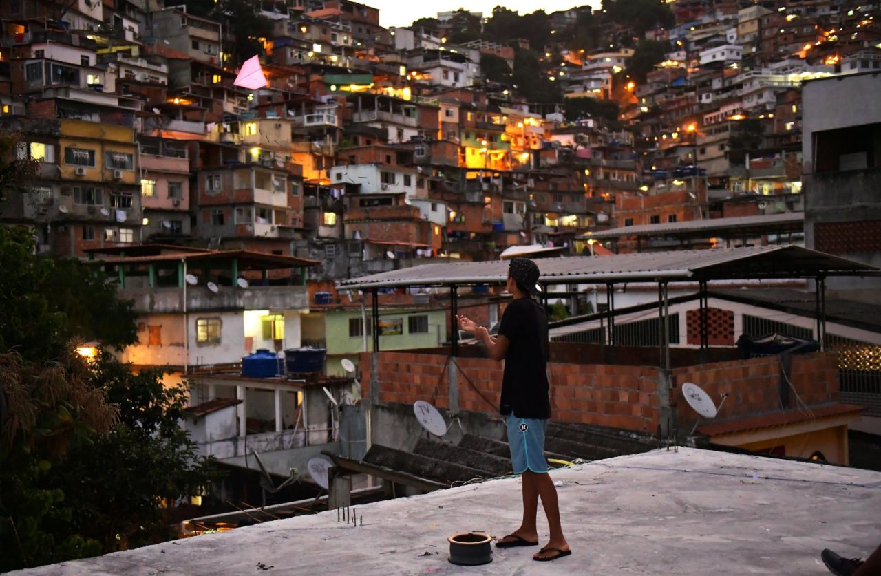 A youngster flies a kites at Vidigal favela, in Rio de Janeiro