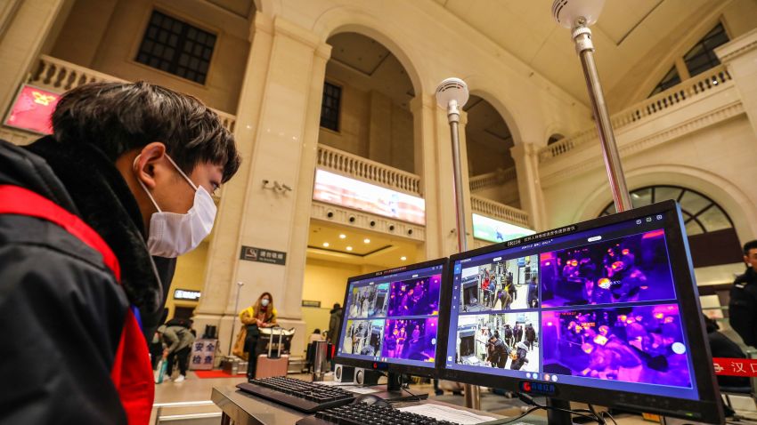 A staff member screens arriving passengers with thermal scanners at Hankou railway station in Wuhan, in China's central Hubei province on January 21, 2020. - Asian countries on January 21 ramped up measures to block the spread of a new virus as the death toll in China rose to six and the number of cases surpassed 300, raising concerns in the middle of a major holiday travel rush. (Photo by - / AFP) / China OUT (Photo by -/AFP via Getty Images)