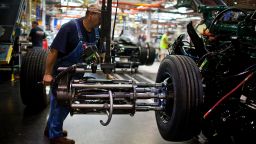 An employee prepares a tire to be mounted onto a truck chassis at the Volvo AG New River Valley Plant in Dublin, Virginia, U.S., on Thursday, May 2, 2013. 