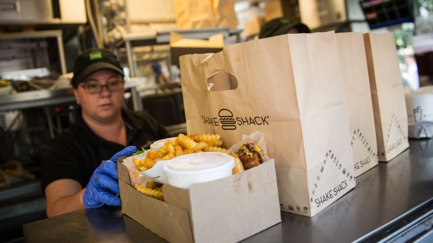 NEW YORK, NY - AUGUST 18: Shake Shack workers prepare orders on August 18, 2014 in Madison Square Park in New York City. Shake Shack is allegedly considering going public and holding an initial price offering (IPO). (Photo by Andrew Burton/Getty Images)